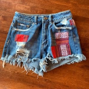 Frayed denim shorts with printed patch work